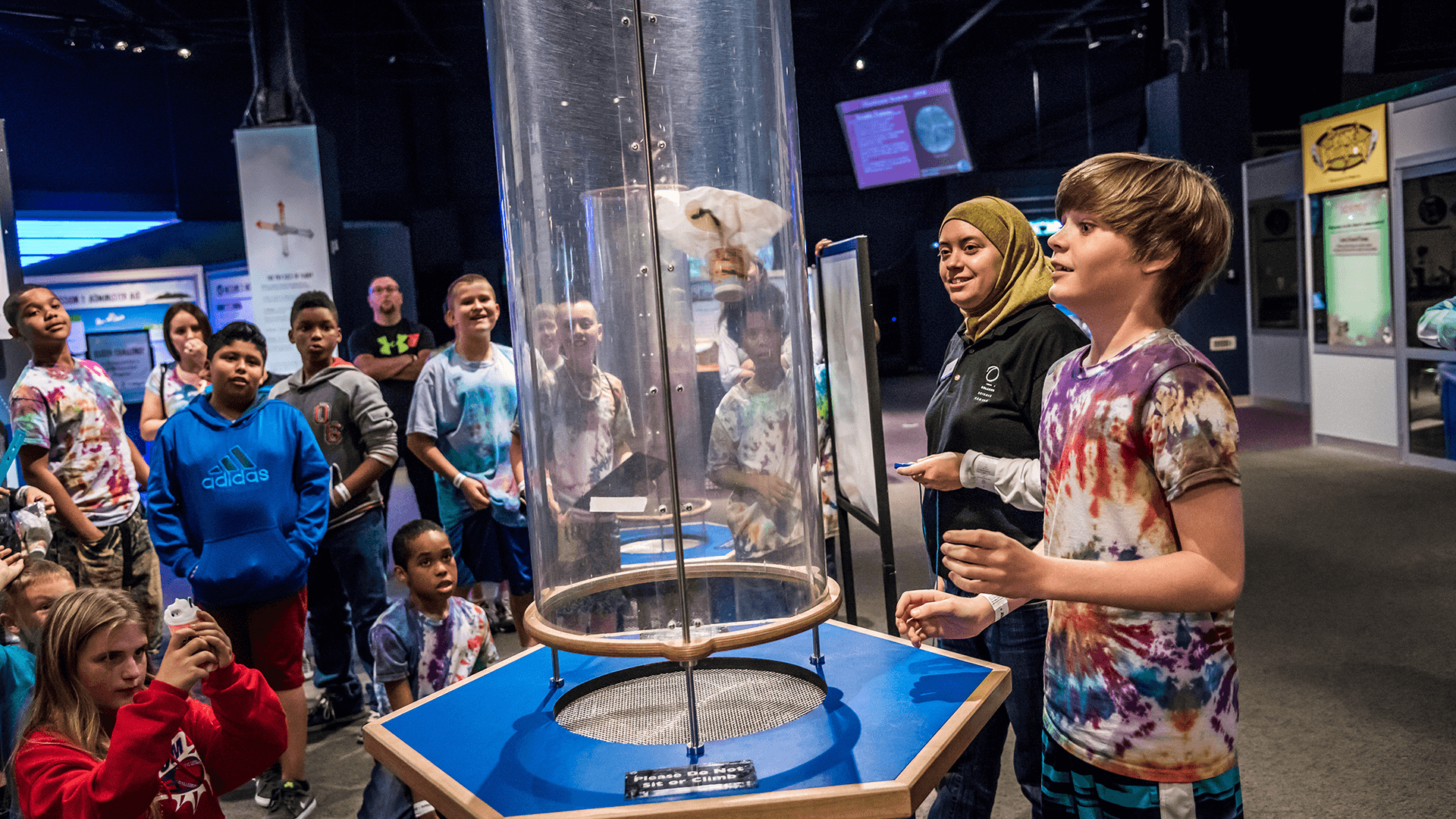 Students do a wind tube engineering activity in the Our Planet exhibit.