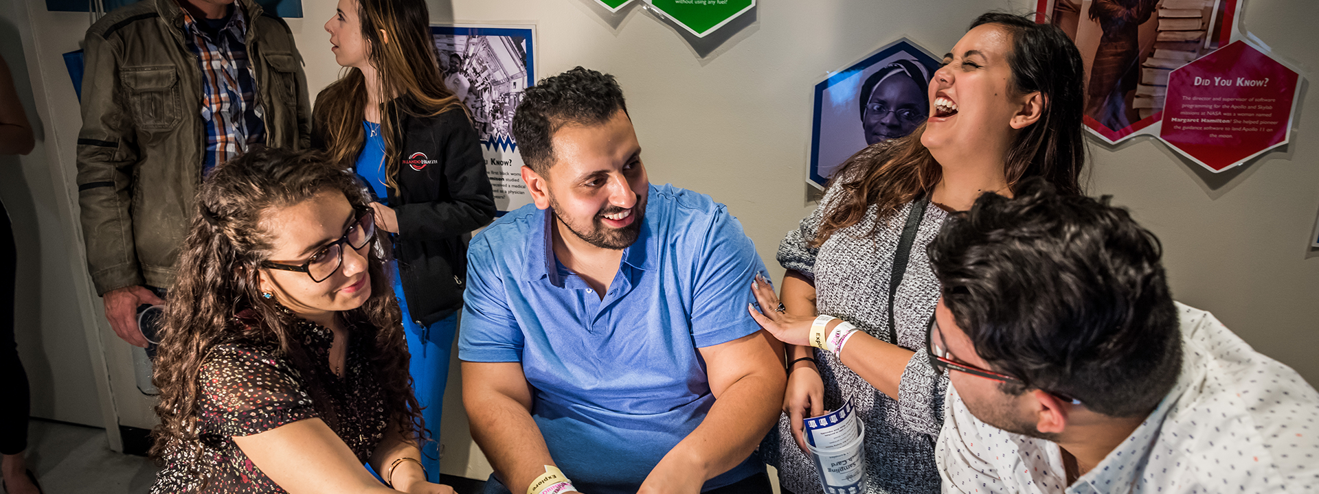 A group of adults do experiments together in Dr. Dare's Lab.