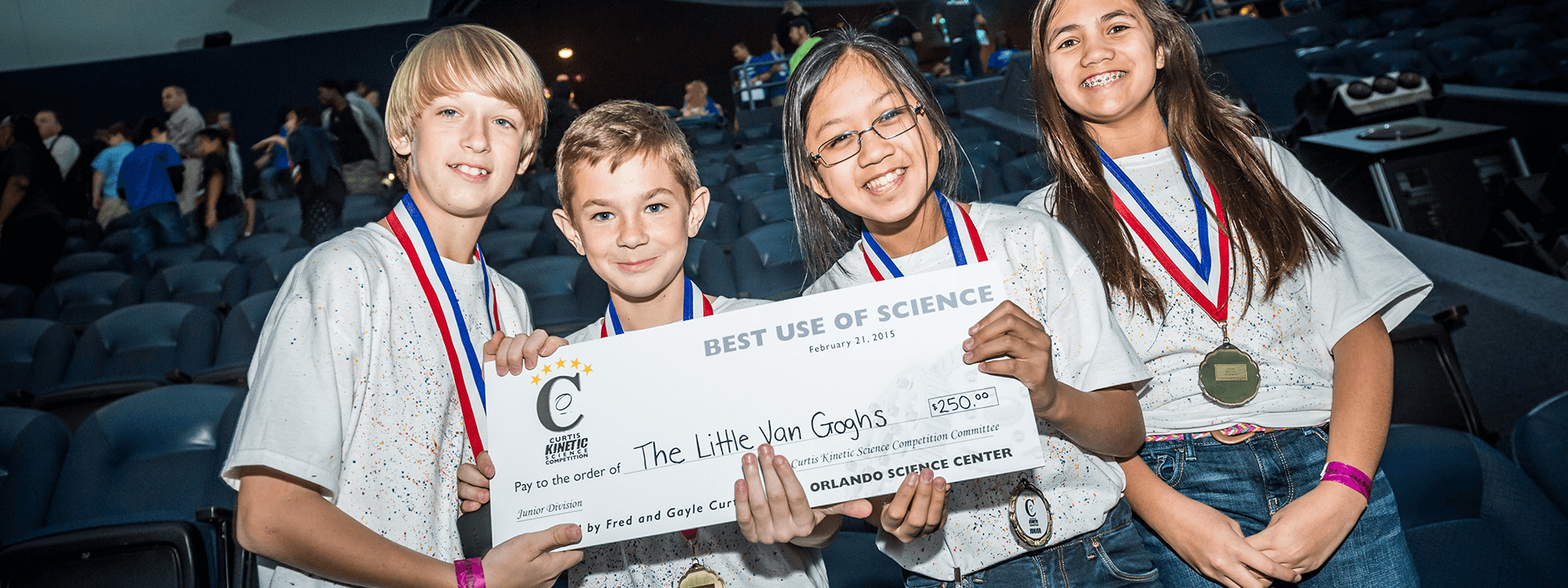 Middle school students display their giant check prize after the Curtis Kinetic Science Competition.