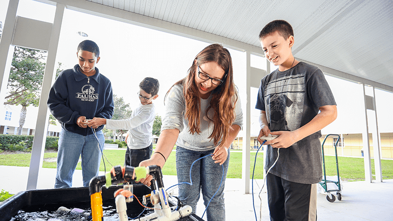 Fifth graders in afterschool program using robotics at their school.