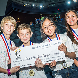 Middle school students display their giant check prize after the Curtis Kinetic Science Competition.