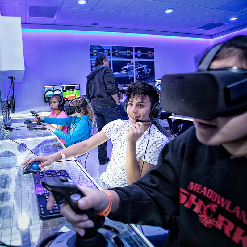 Students learning to fly a plane with virtual reality simulation.