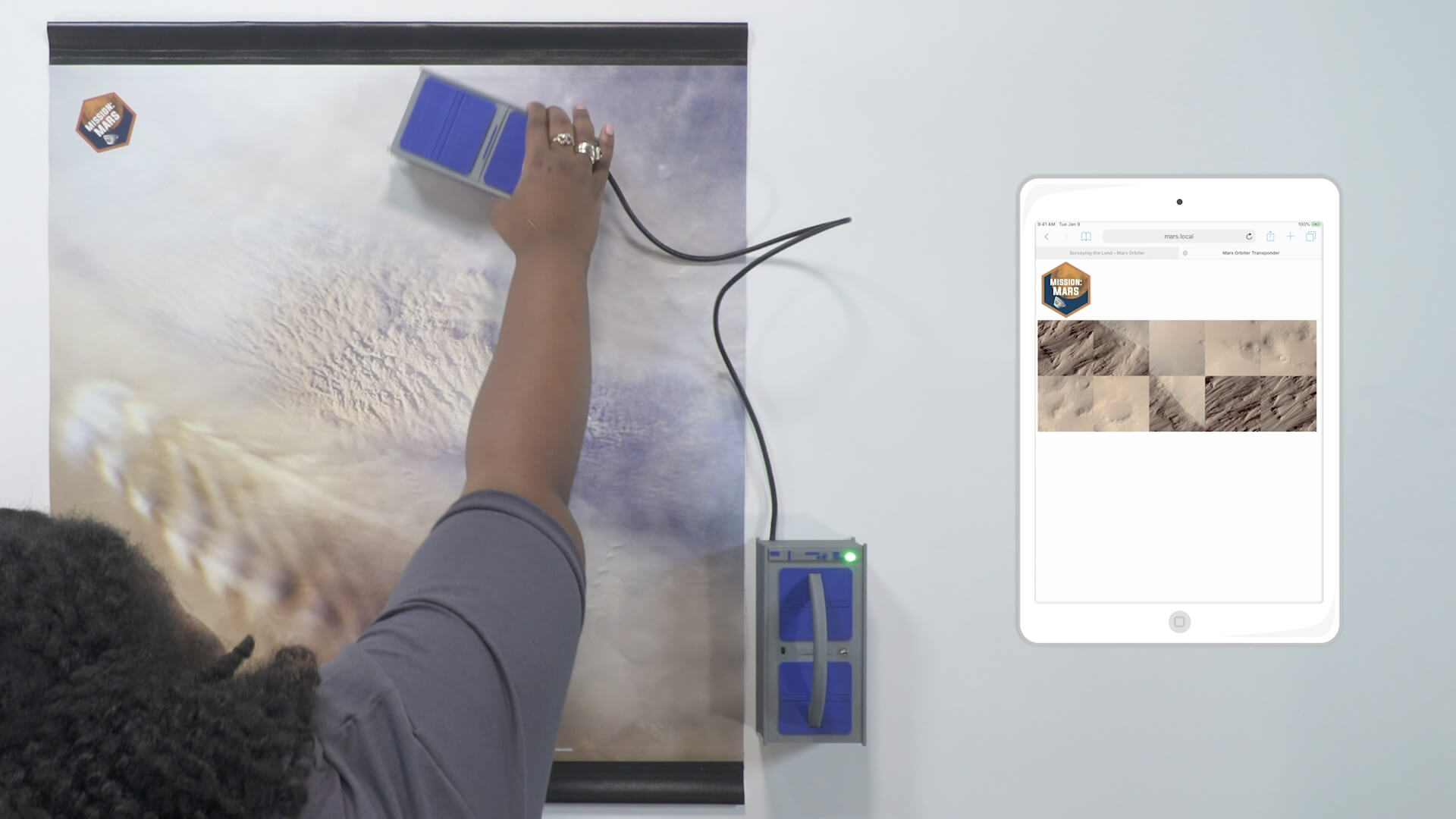 Mission: Mars team member demonstrating Surveying the Land activity within a video presentation.