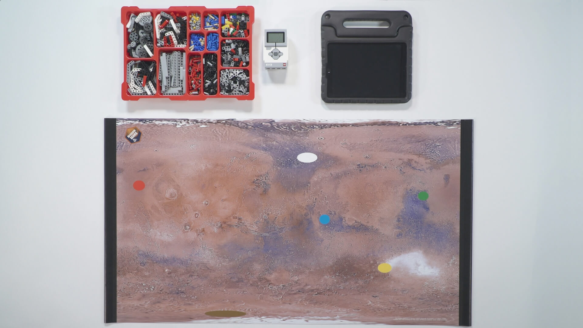 Mission: Mars Surveying the Land activity mat with bin of Lego parts within a video presentation.