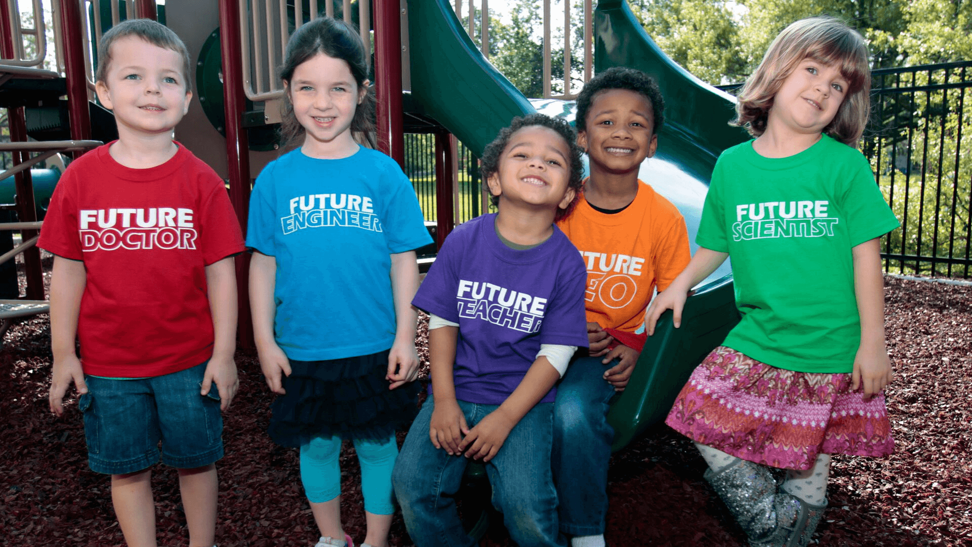 Five preschool students smiling for a photo on the Science Center's Playground