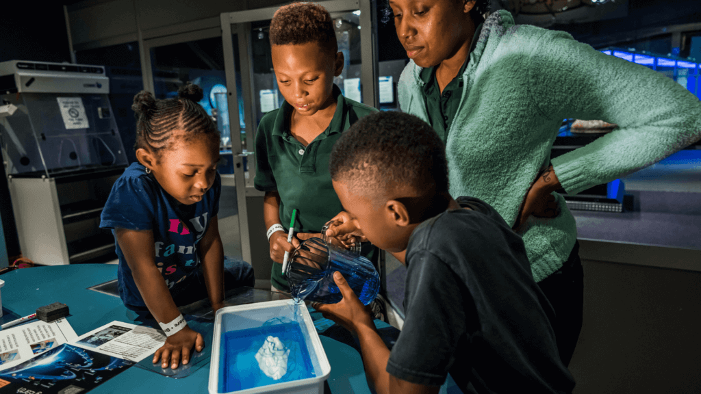 Kids doing an experiment in Dr. Dare's Lab