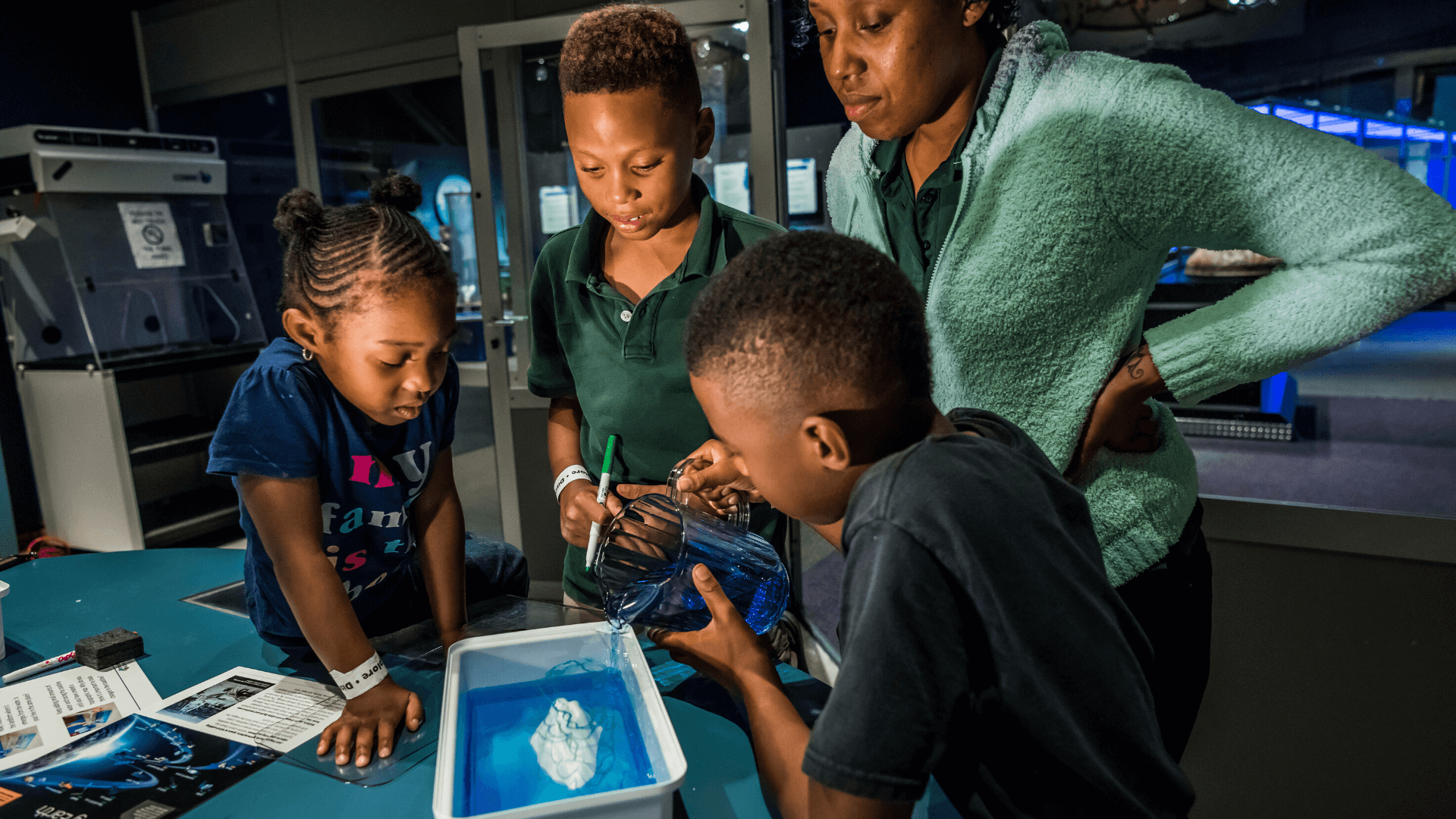 Kids doing an experiment in Dr. Dare's Lab