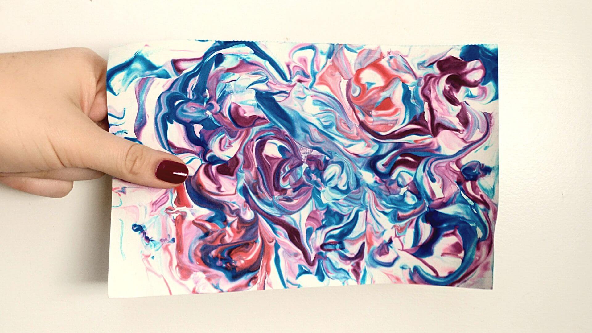 homemade gift inspired by science: a piece of blue, purple, and red marbleized paper