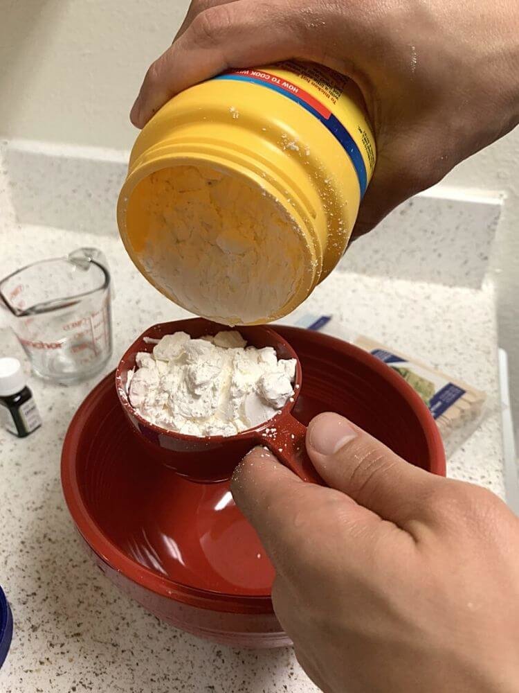 mix-oobleck-recipe-ingredients-together-in-mixing-bowl Add cornstarch to mixing bowl