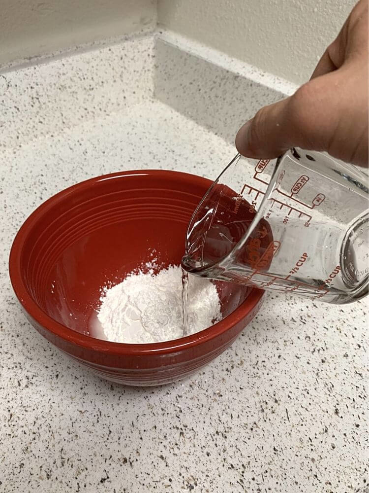 mix-water-into-oobleck Add water to mixing bowl