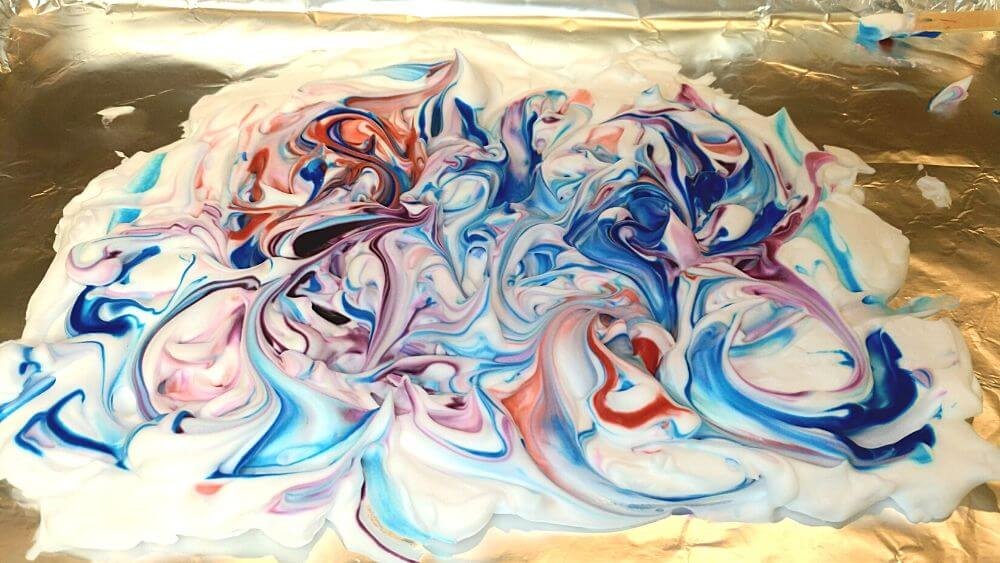 Swirl shaving cream colors together to make marbleized effect