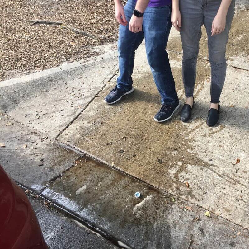 two people standing in a puddle of diet coke