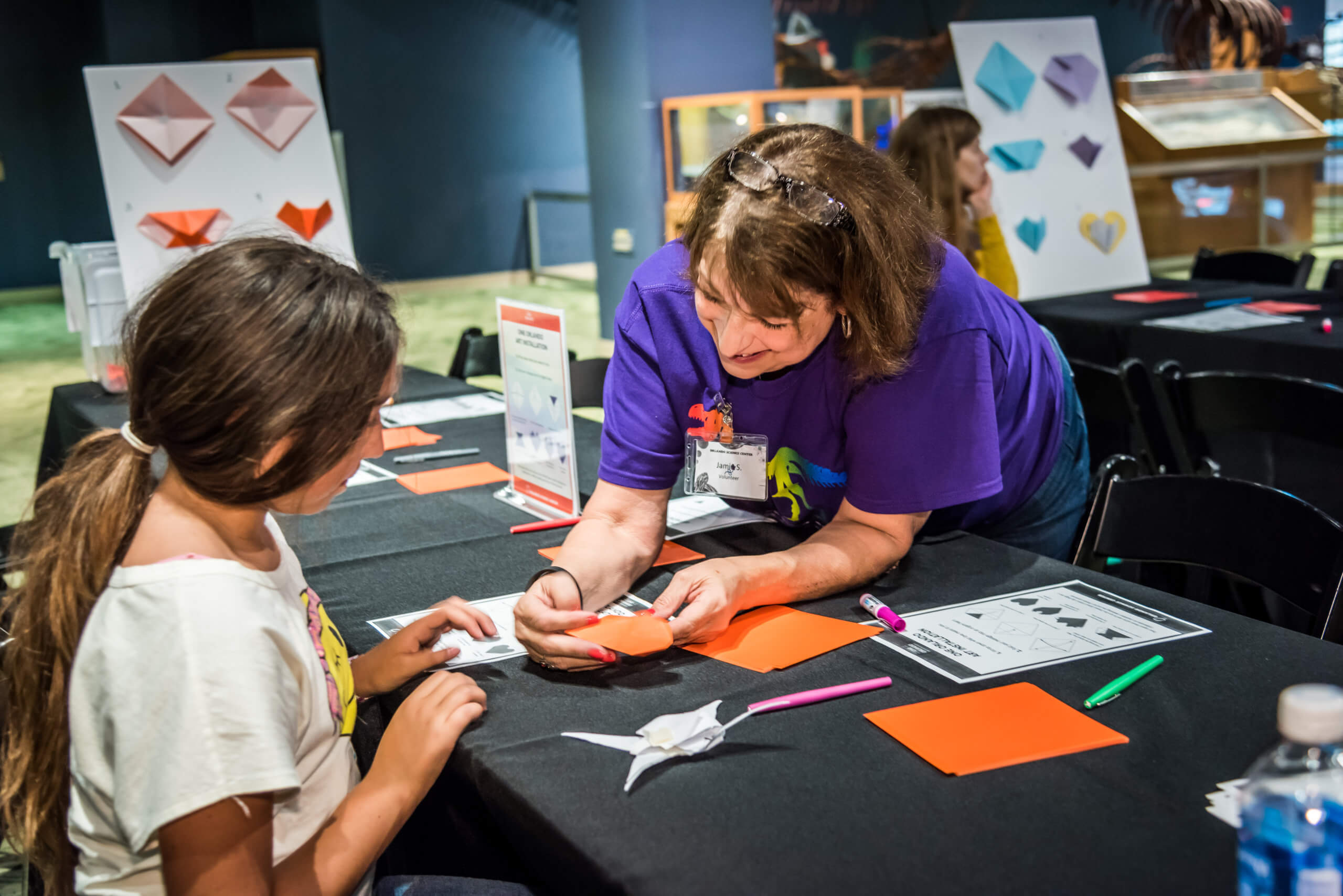 A girl fold paper into origami heart for Pulse nightclub tribute