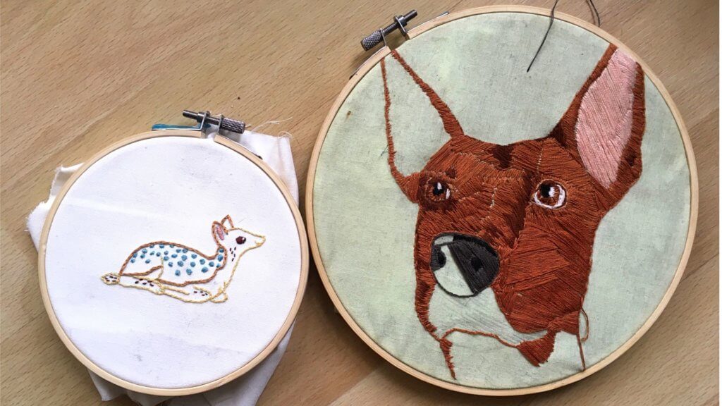 A deer and dog made using different embroidery techniques