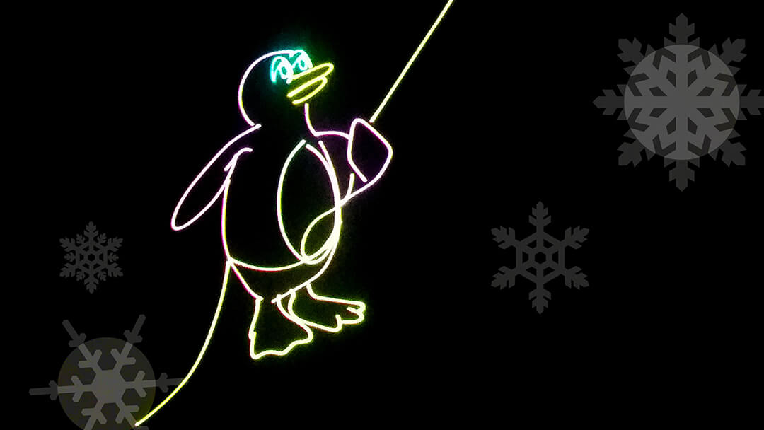 Image of snowflakes and penguin in laser light.