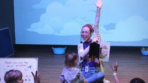 KidsTown-StoryTime_1080x608 KidsTown presenter raising hand during StoryTime