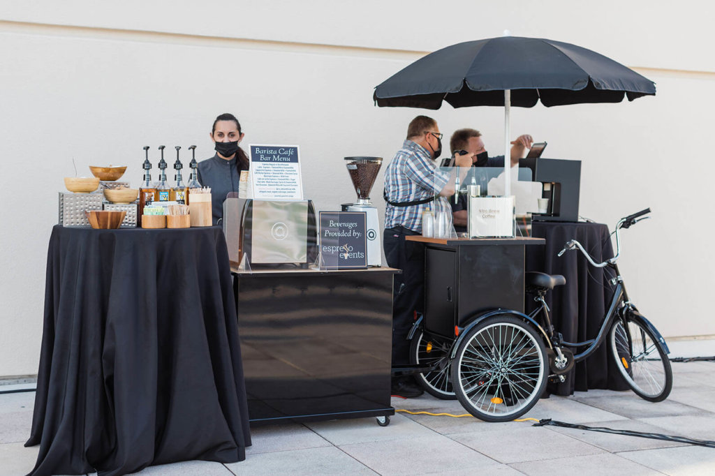 an espresso cart and table of sweets