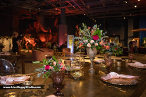 a table full of flower arrangements 