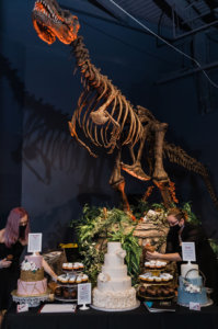 a wedding cake in front of a T. Rex