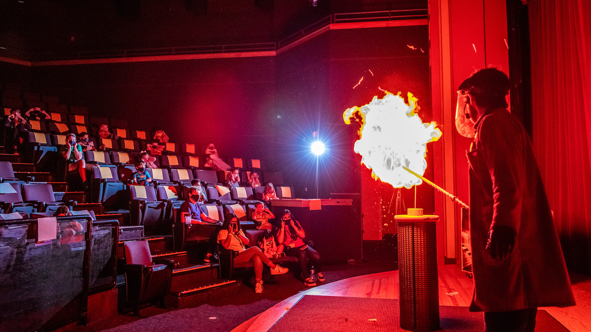 An OSC Science Program Interpreter explodes a balloon of flammable gas on stage during a KABOOM! Live Show