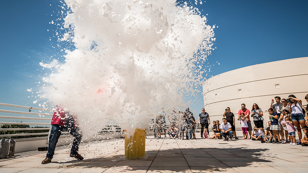 Guests watch large cloud of foam exploding during outdoor Science Live show.