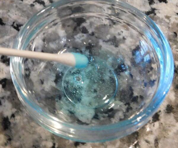 Add dish soap to a qtip to create tie-dye milk effect