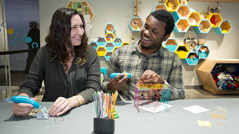 Two guests making crafts together with 3-Doodler pens in The Hive: a Makerspace.