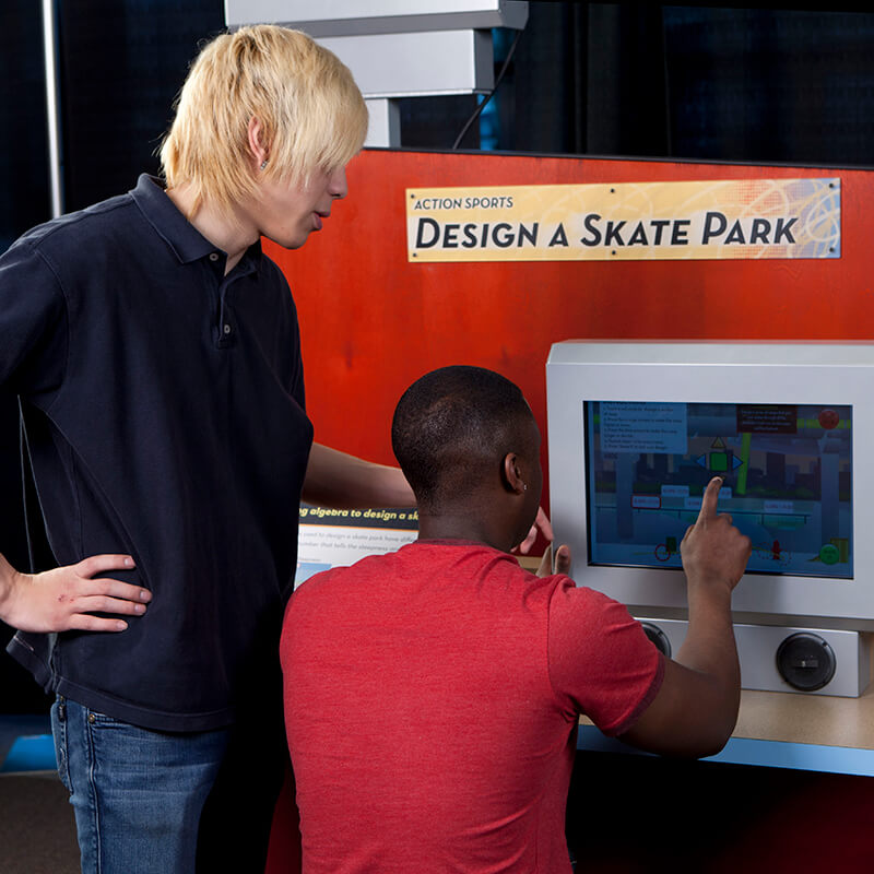 two teenagers designing a virtual skatepark