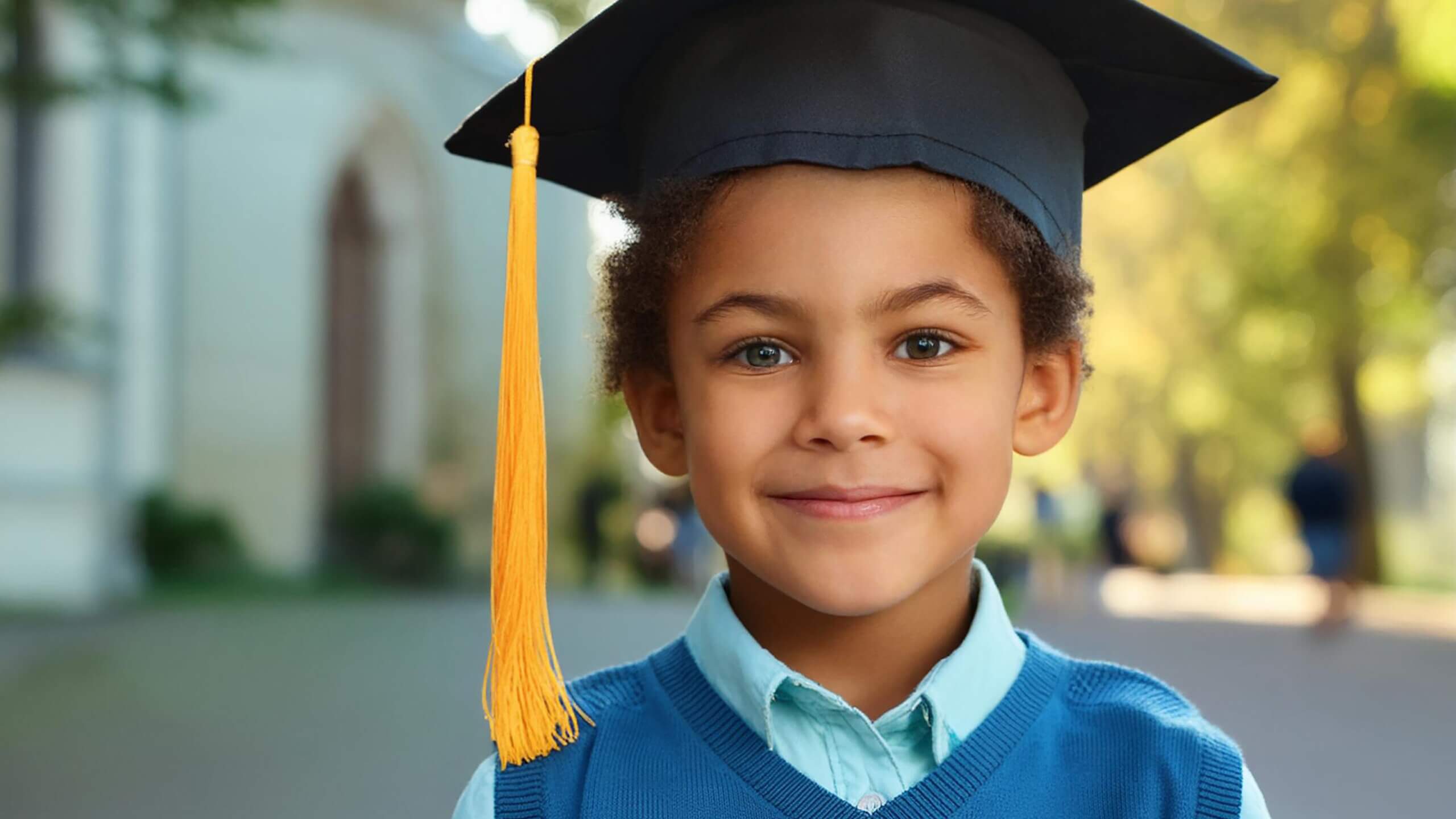 a little boy in a graduation cap