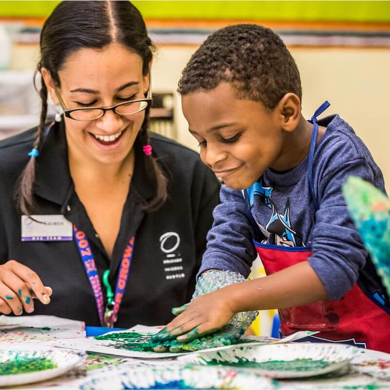 a preschool boy finger painting