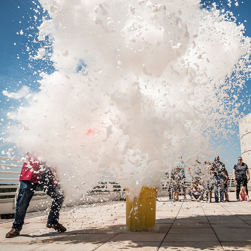 Guests watch large cloud of foam exploding during outdoor Science Live show.