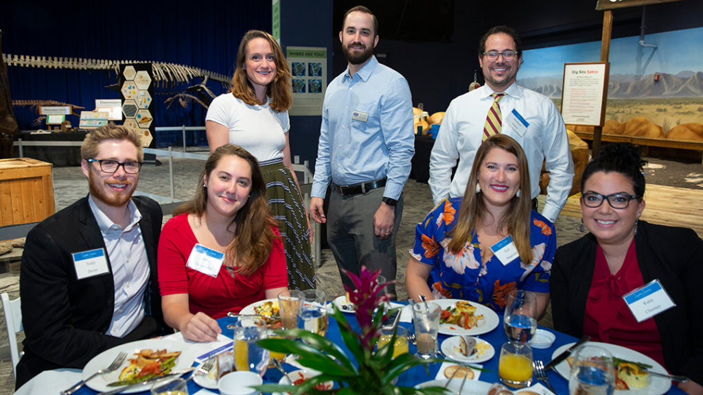 Table setting with seven guests at Inspire Science Breakfast.