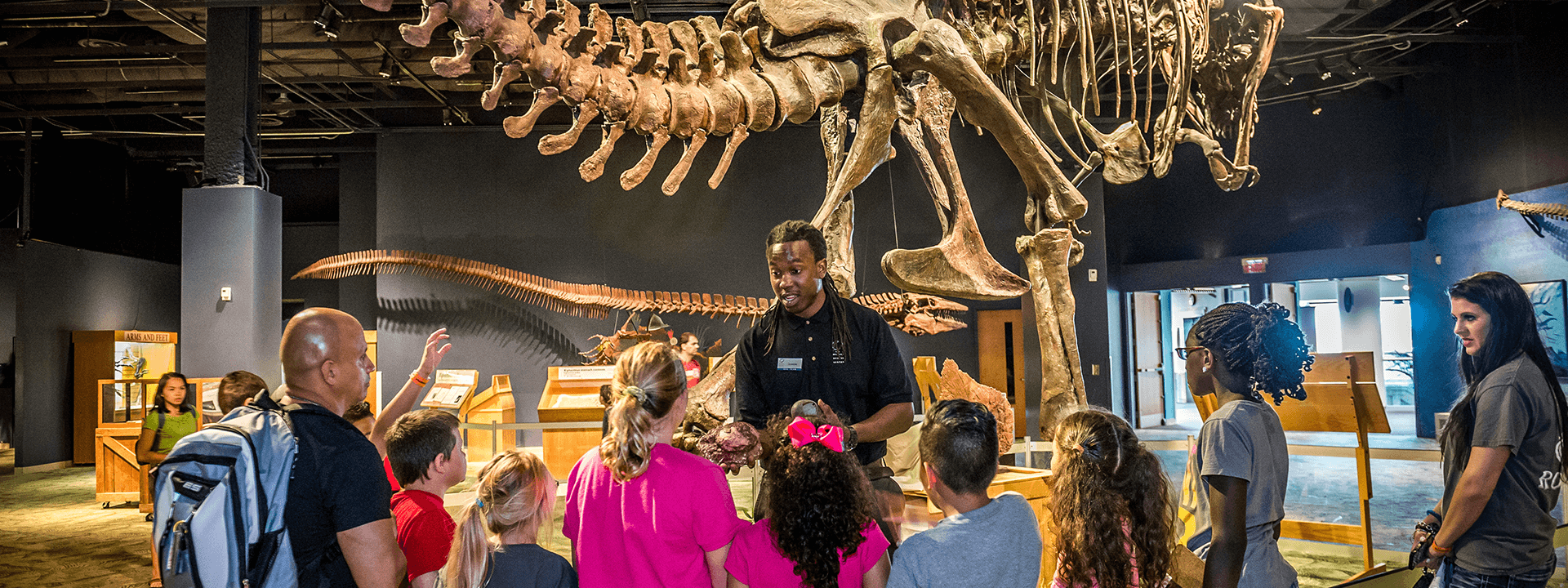 A Science Center educator teaches a field trip group in the DinoDigs exhibit.