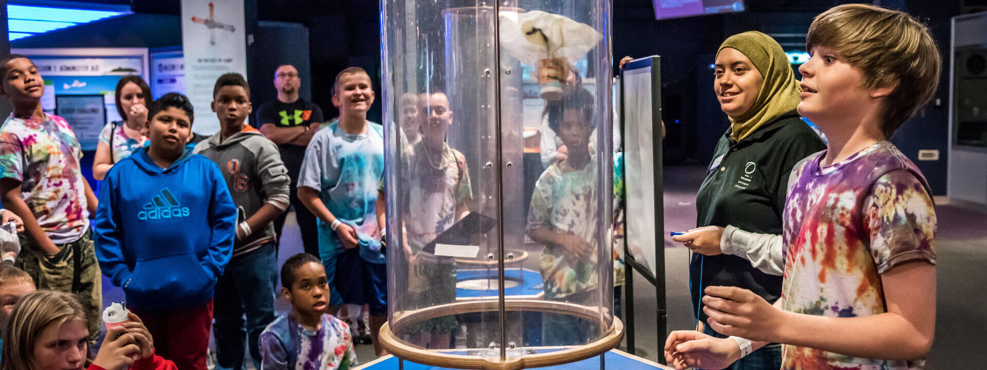 Students do a wind tube engineering activity in the Our Planet exhibit.