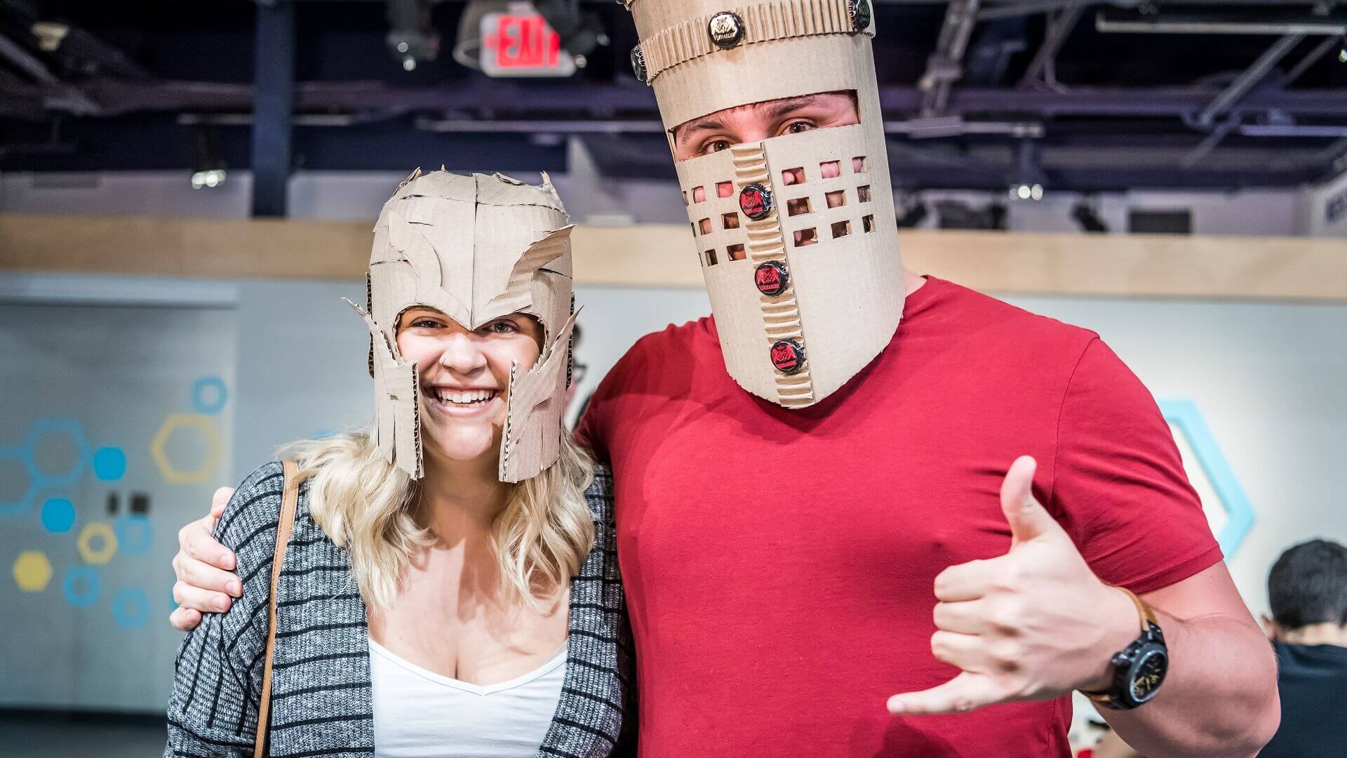 Couple wearing creative cardboard knight helmets at OSC.