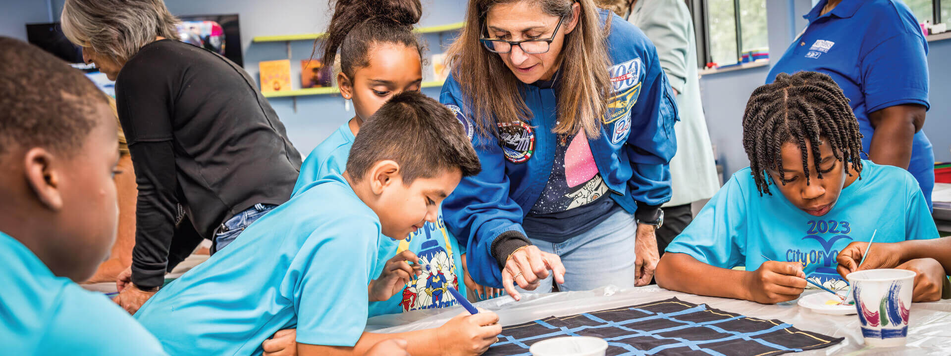 Students and facilitators participating in STEM activities at Neighborhood Science classroom.