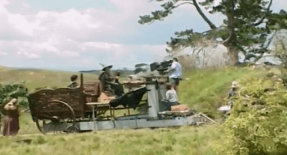 BTS photo showing a custom carriage where Frodo's seat is further back to give the illusion that he is of Hobbit stature when filmed from the right angle