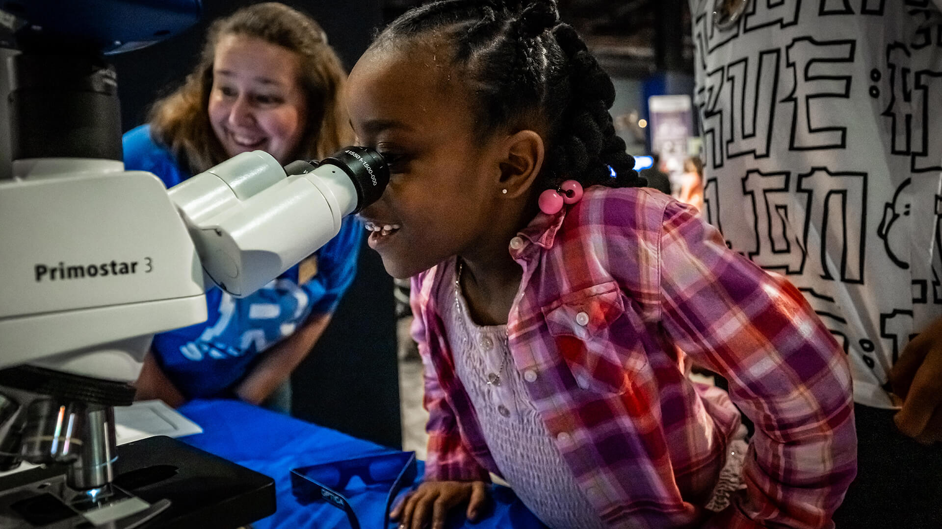 Guest interaction at a Spark Stem Fest 2025 exhibitor booth.
