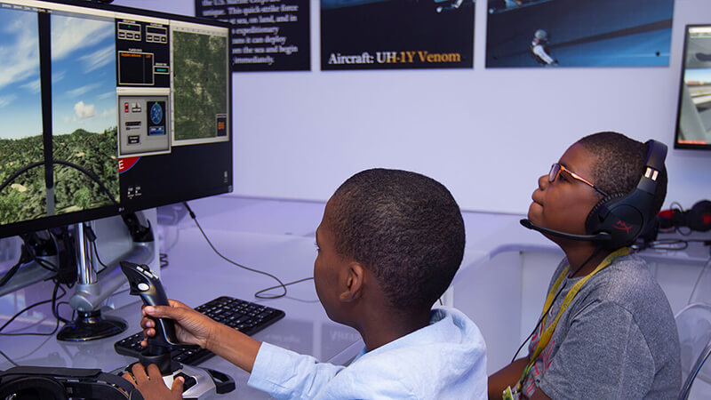 Avation-Adventures-Flight-Lab_800x450 Two students using a computer flight simulator