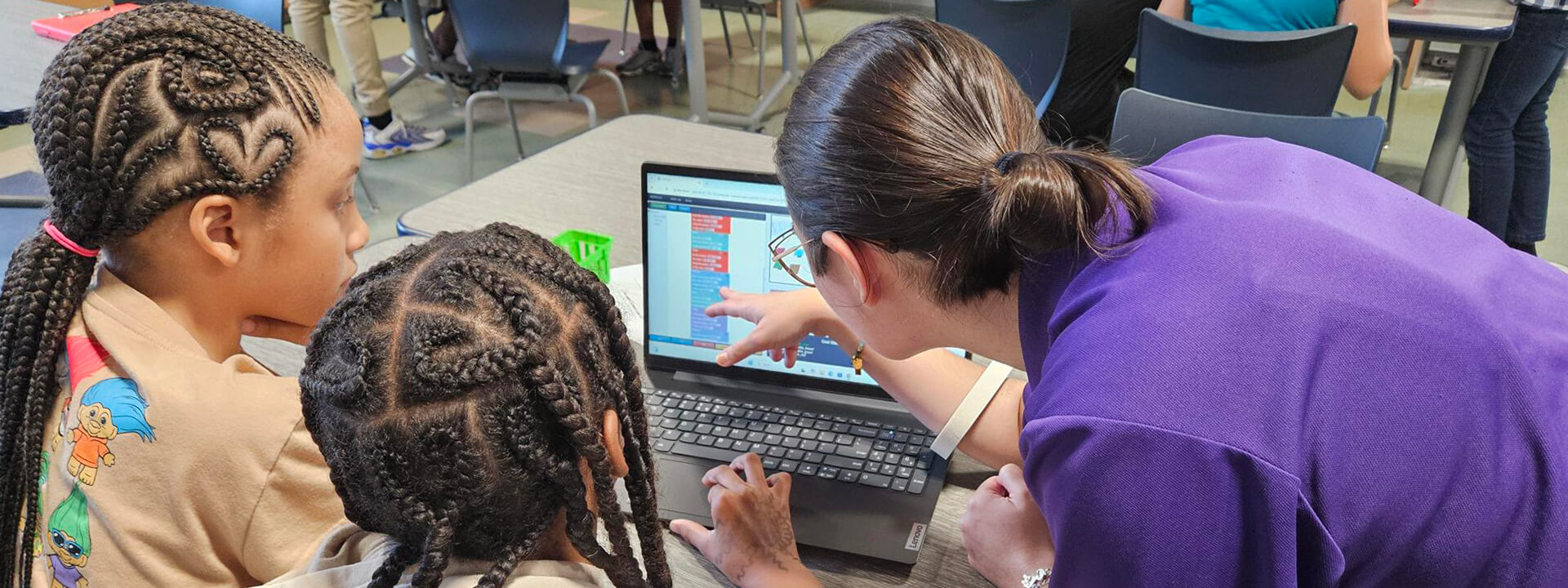 _Naval-STEM-Adventures-Program_1920x720 Two students interact on laptop computer along with facilitator during Naval Stem Adventures program.