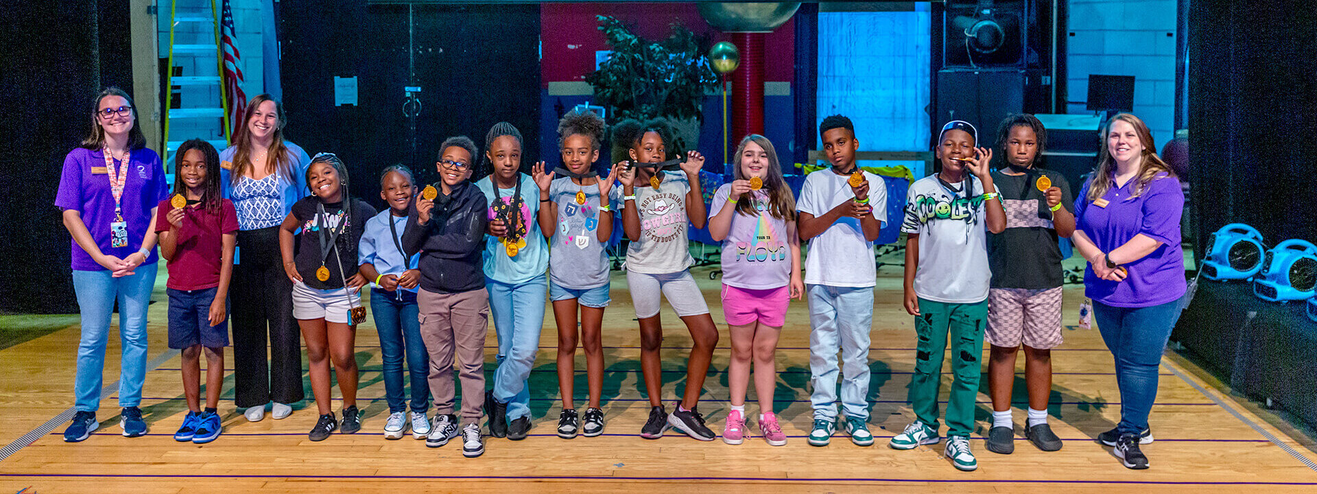 Class of students and Educators lined up on stage during Naval STEM Adventures presentation for Neighborhood Science.