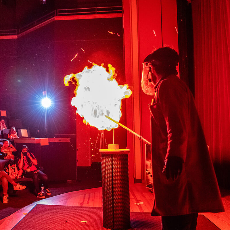 OSC-KaBoom-Live-Show-2020_800x800 An OSC Science Program Interpreter explodes a balloon of flammable gas on stage during a KABOOM! Live Show