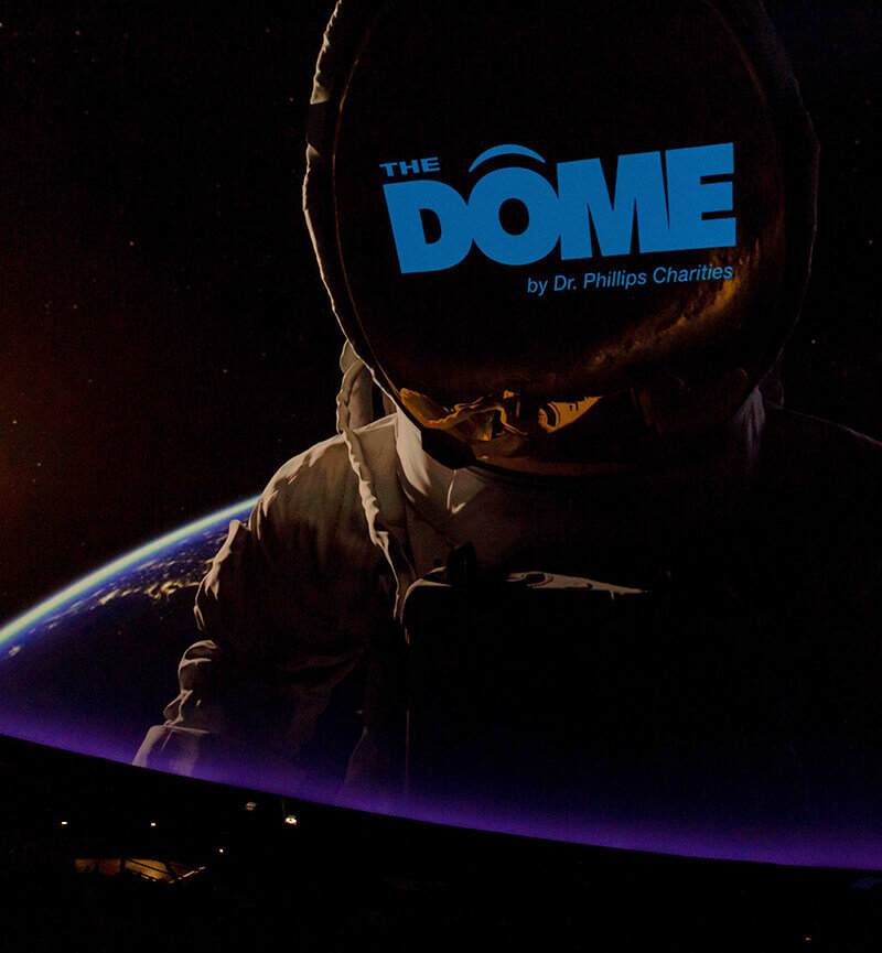 Astronaut image With Dome by Dr. Phillips Charities Logo over the face.