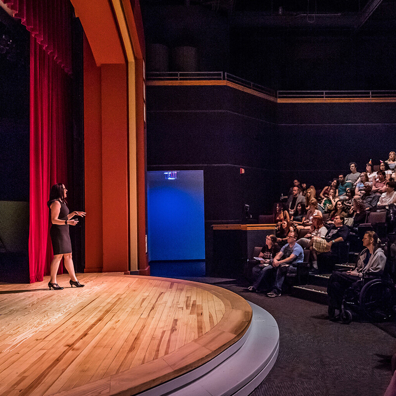 digital-adventure-theater-orlando-science-center-live-presentations_800x800 Guests listening to presenter on stage of Digital Adventure Theater.